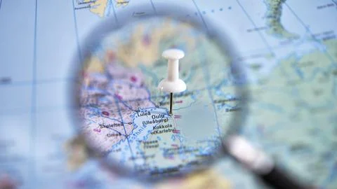 A close-up of a printed map with Oulu marked at a specific location. Stock Photos