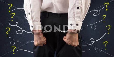Close prisoner hand with questions around Stock Photos
