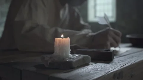 Close up of prisoner hands putting out a candle inside a gloomy dungeon cell Stock Footage 341466739