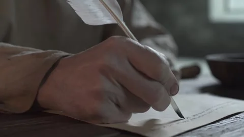 Close up of prisoner hands writing Latin text on parchment, camera tracking Stock Footage 337929863