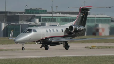 Close up of private jet going down runway before takeoff Stock Footage 310886336