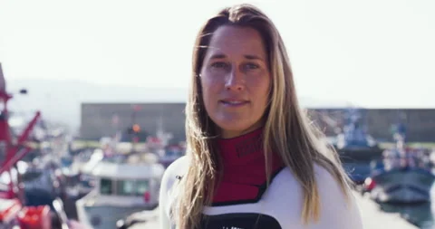 Close up of pro surfer Aline Van Haren posing with surfboard and smiling Stock Footage 156624994