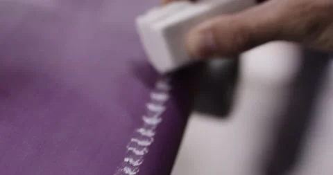 Close up of pro surfer applying thin layer of wax on edge of surfing board Stock Footage 158060453