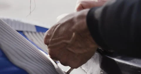 Close up of pro surfer David Langer attaching and fixing rope to rescue sled Stock Footage 163072053