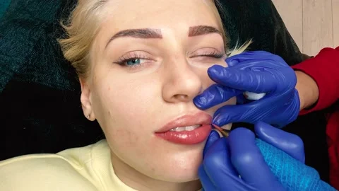 Close-up of the process of applying permanent makeup to the lips. 4k Video stock 164246816