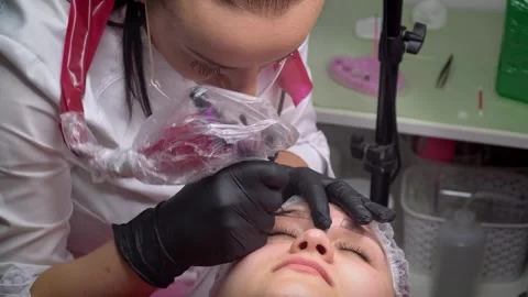 Close up process of applying permanent makeup tattoo of brown on eyebrows woman  Stock Footage 300877479