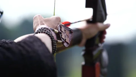 Close up, the process of the archer pulling the bow arrow to shoot at the Stock Footage 247160550