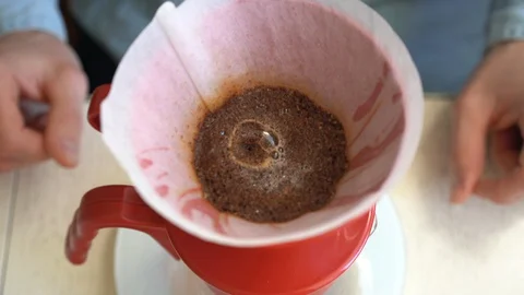 Close up process of brewing specialty coffee in the funnel filter at home Stock Footage 128676149