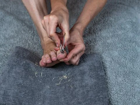 Close-up of the process of caring for the nails of the toes. A woman takes care Stock Photos