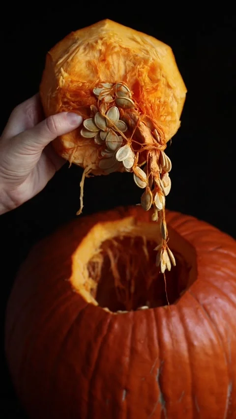A close-up of the process of cleaning a fresh autumn pumpkin Video stock 347608678