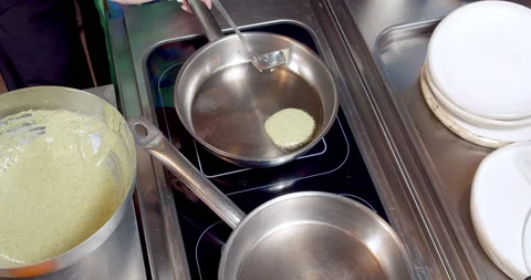 Close-up of the process of cooking delicious pancakes in a frying pan. Stock Footage 153901370