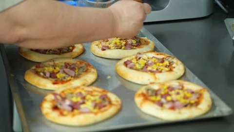 Close-up, the process of cooking several mini pizza from yeast dough, with Stock Footage 103577038