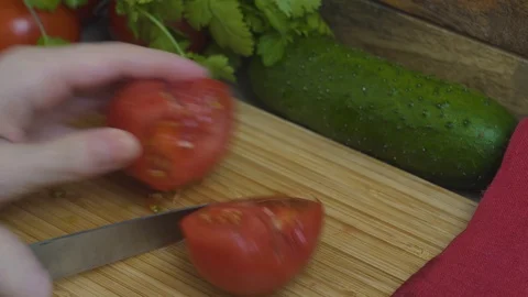 Close up, the process of cutting fresh red juicy tomato on a bamboo Board, healt Stock Footage 108025040