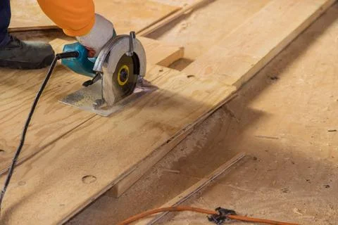 Close Up process cutting of hand circular saw at wood plywood cuts Stock Photos