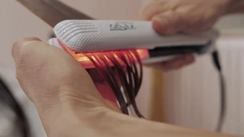 Close-up of the process of diagnosing and treating a girl's long brown hair for Stock Footage 155739929