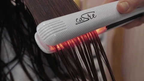 Close-up of the process of diagnosing and treating a girl's long brown hair for Stock-Footage 155741956