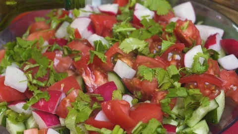 Close up, the process of dressing a salad of fresh colorful vegetables tomatoes  Stock Footage 108024739