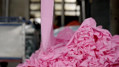 Close-up of the process of dyeing fabric pink. VietNam Cloth Dyeing Factory. Stock Footage 247404150