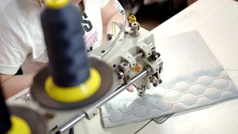 Close up process of embroidering diamond pattern on cowhide in atelier on step Stock Footage 177131846