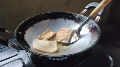 A Close-up of The Process of Frying Crackers Видео 332450190