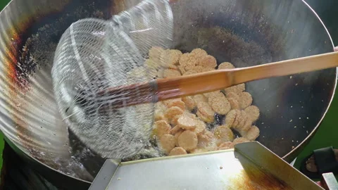 Close-up process of frying crispy rice crackers in the hot oil and frying pan Stock Footage 311083703