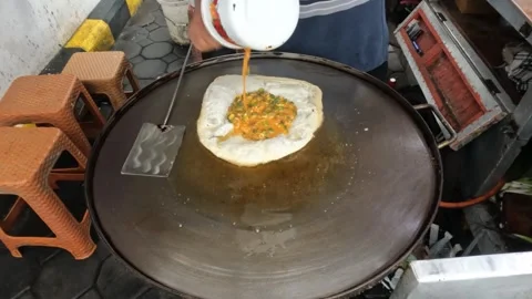 Close up of the process of frying martabak Stock Footage 306669528