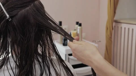 Close-up of the process of highlighting and cutting a girl's long brown hair for Stock-Footage 155740155