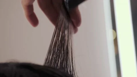 Close-up of the process of highlighting and cutting a girl's long brown hair for Stock-Footage 155740520