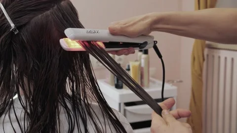 Close-up of the process of highlighting and cutting a girl's long brown hair for Stock Footage 155741102