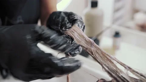 Close-up of the process of highlighting and washing a girl's long brown hair for Stock-Footage 155740650