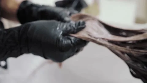Close-up of the process of highlighting and washing a girl's long brown hair for Stock-Footage 155741733