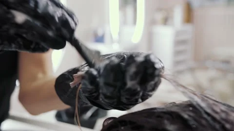 Close-up of the process of highlighting and washing a girl's long brown hair for Stock-Footage 155742261