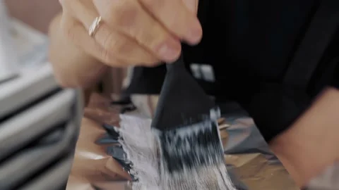 Close-up of the process of highlighting the long brown hair of a girl. The Stock-Footage 155740395