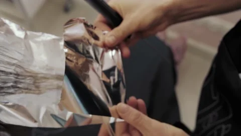 Close-up of the process of highlighting the long brown hair of a girl. The Stock-Footage 155742342