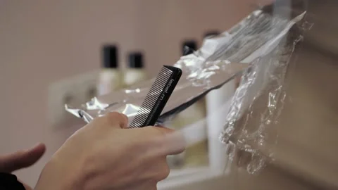 Close-up of the process of highlighting the long brown hair of a girl. The Stock-Footage 155742607