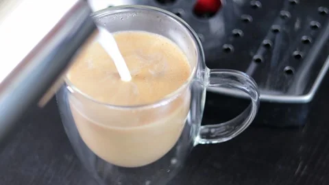 Close-up of the process of making cappuccino. Pour frothed milk into a cup. Stock Footage 248968771