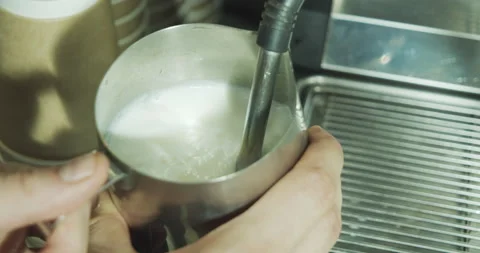Close up of the process of making coffee. Barista shaking milk for cappuccino Stock Footage 136354069