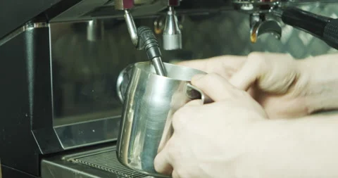 Close up of the process of making coffee. Professional barista shaking milk Stock Footage 136338451