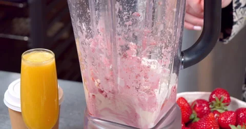 Close-up process of making delicious strawberry cream or smoothie using a Stock Footage 153837773
