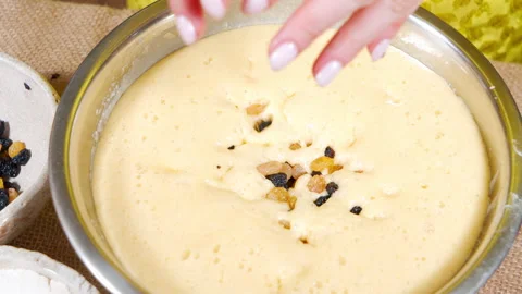 Close-up of the process of making dough for Easter cake or raisin muffins. Stock Footage 153479700