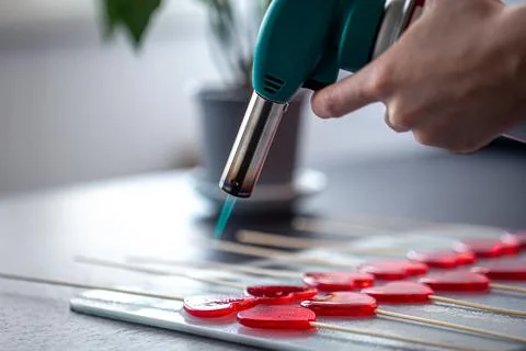 Close-up, the process of making heart-shaped lollipops. Stock Photos