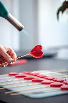 Close-up, the process of making heart-shaped lollipops. Stock Photos