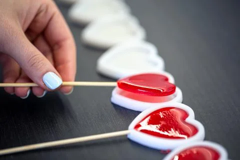 Close-up, the process of making heart-shaped lollipops. Stock Photos