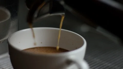 Close-up of the process of making hot coffee in a modern coffee machine, two Vidéo 106295848