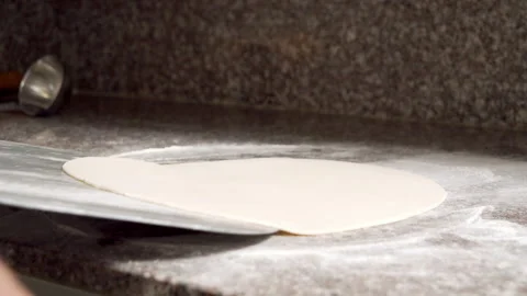 Close-up of process of making pizza in the kitchen. Chef removing pizza dough Stock Footage 145527102