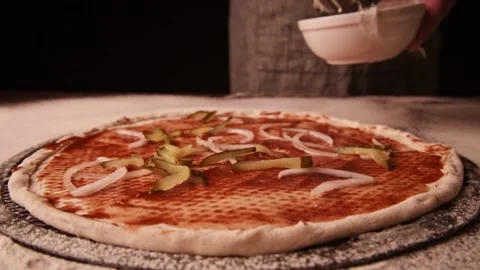 Close up on the process of making pizza at kitchen. Chef putting the ingredients Stock-Footage 149070205