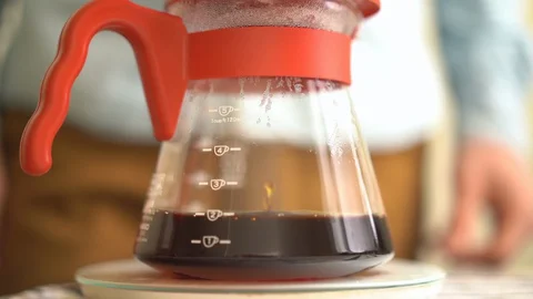Close up process of making specialty coffee drops drip into a vessel Stock Footage 128676214