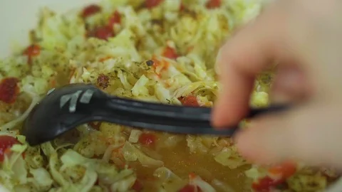 Close-up, the process of mixing boiling vegetables, stewed cabbage with spices a Stock Footage 108460599