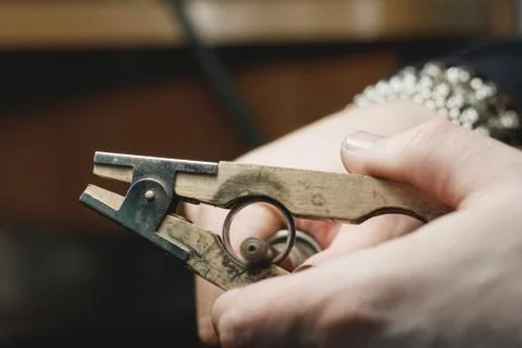 Close-up process of polishing ring made of white gold in a jewelry workshop. Stock Photos