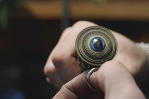 Close-up process of polishing ring made of white gold in a jewelry workshop. Stock Photos